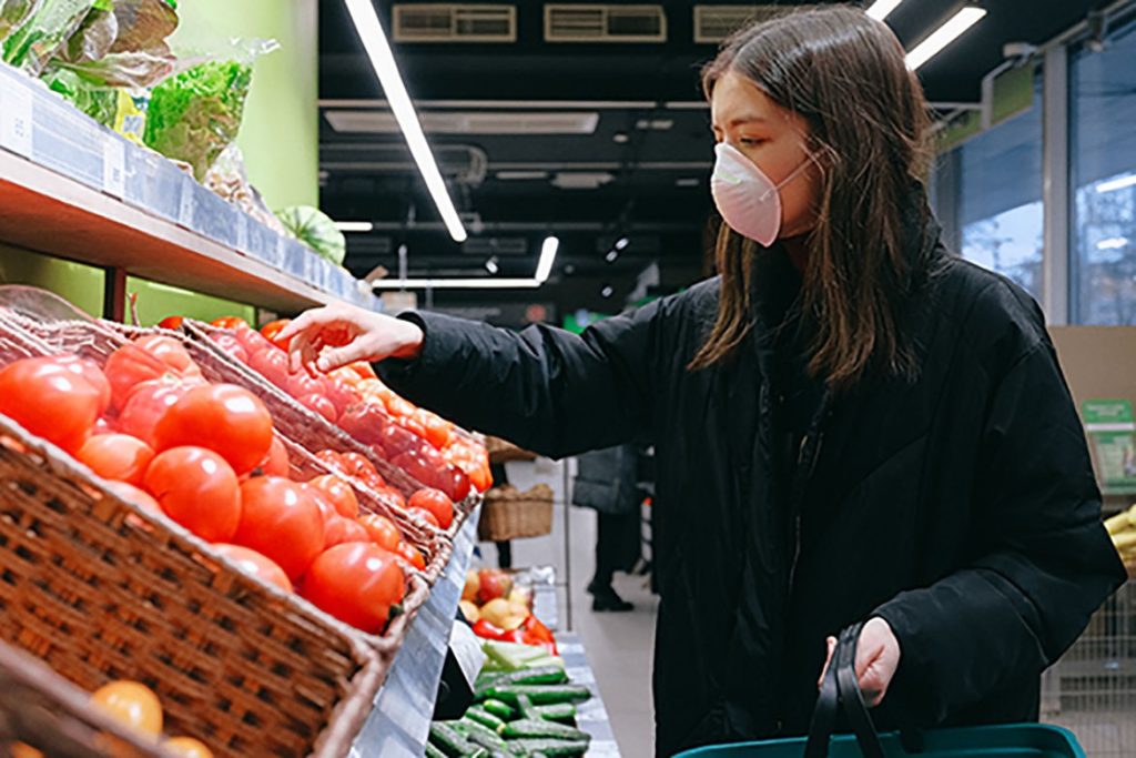 Woman in face mask shopping in a supermarket